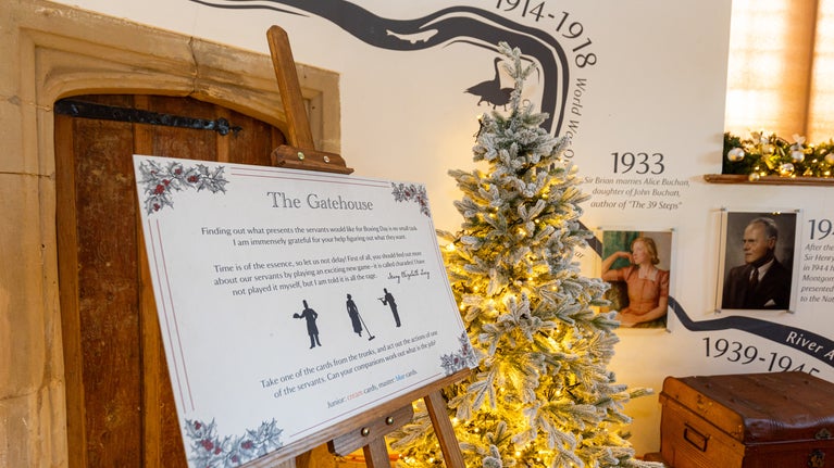 A trail board stands in the Gatehouse among Christmas decorations